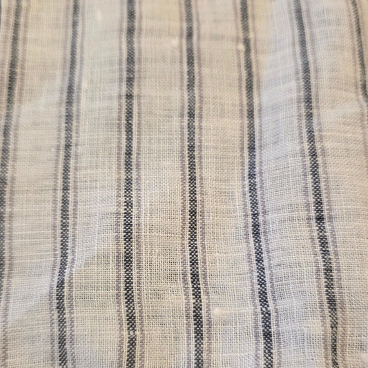 Striped fabric with black and white pattern on a dark background