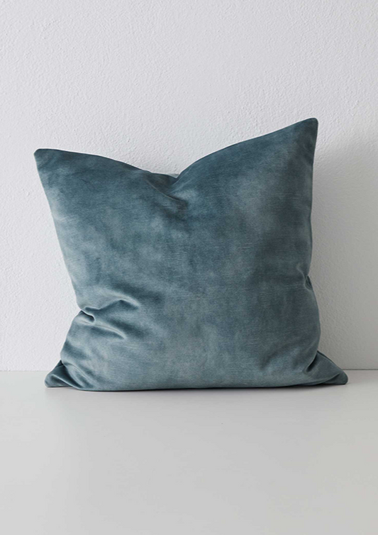 A plush aqua-colored velvet cushion with a concealed zipper, designed to be 50cm x 50cm in size, displayed against a neutral background.