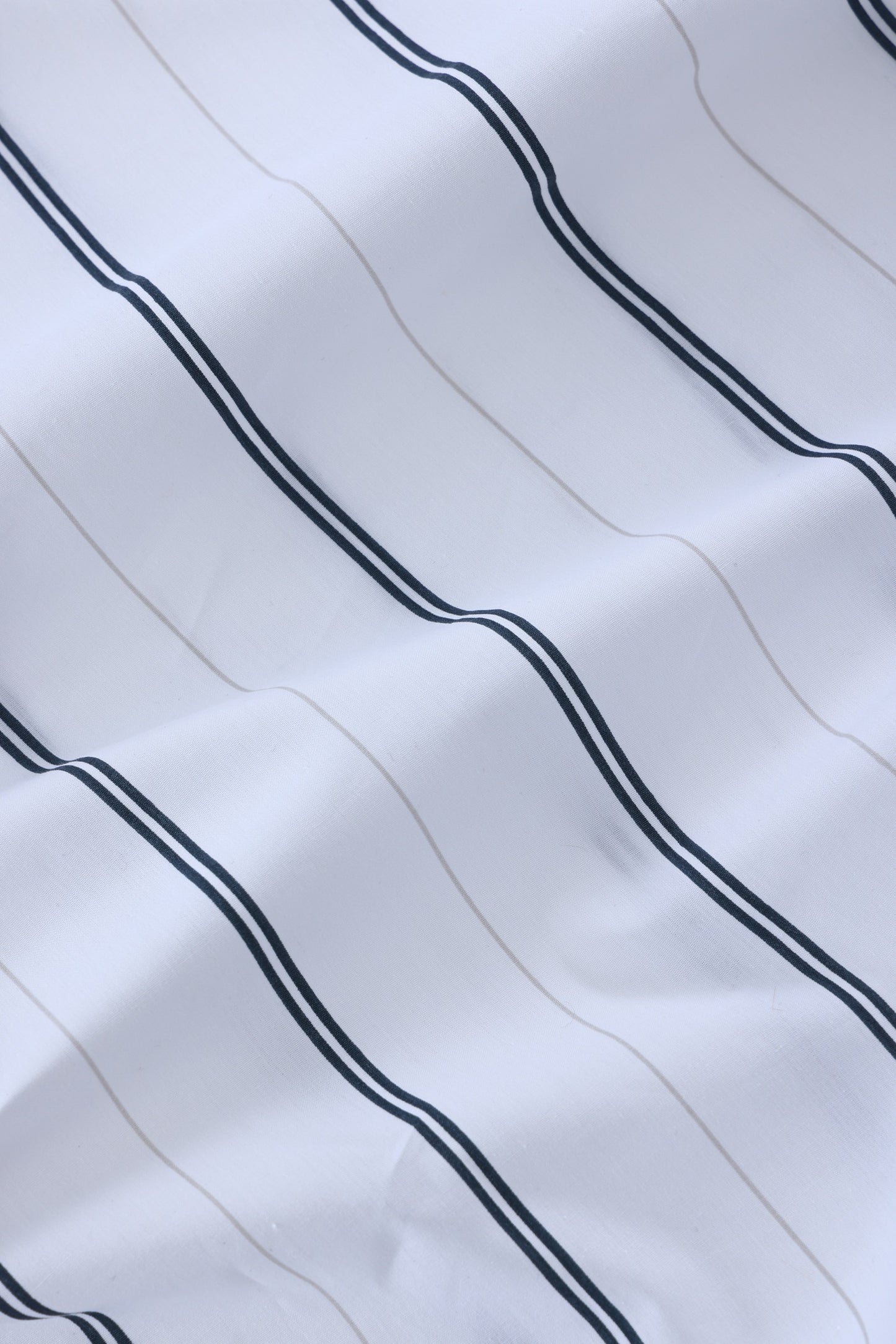 Close-up of white fabric with black stripes