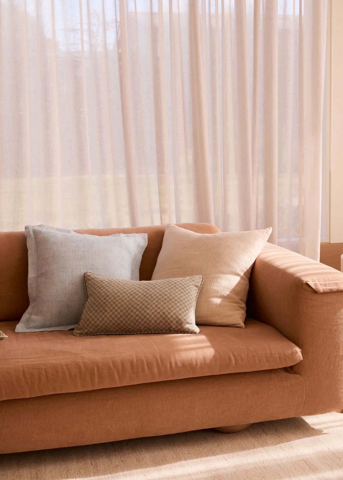 Brown sofa with decorative pillows in a living room setting