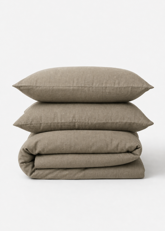 Stack of beige bedding on a white background