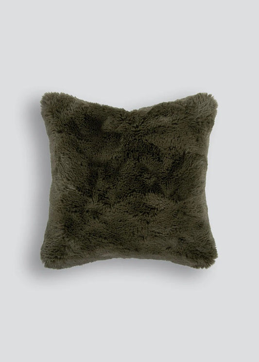 Green fluffy pillow on a light gray background