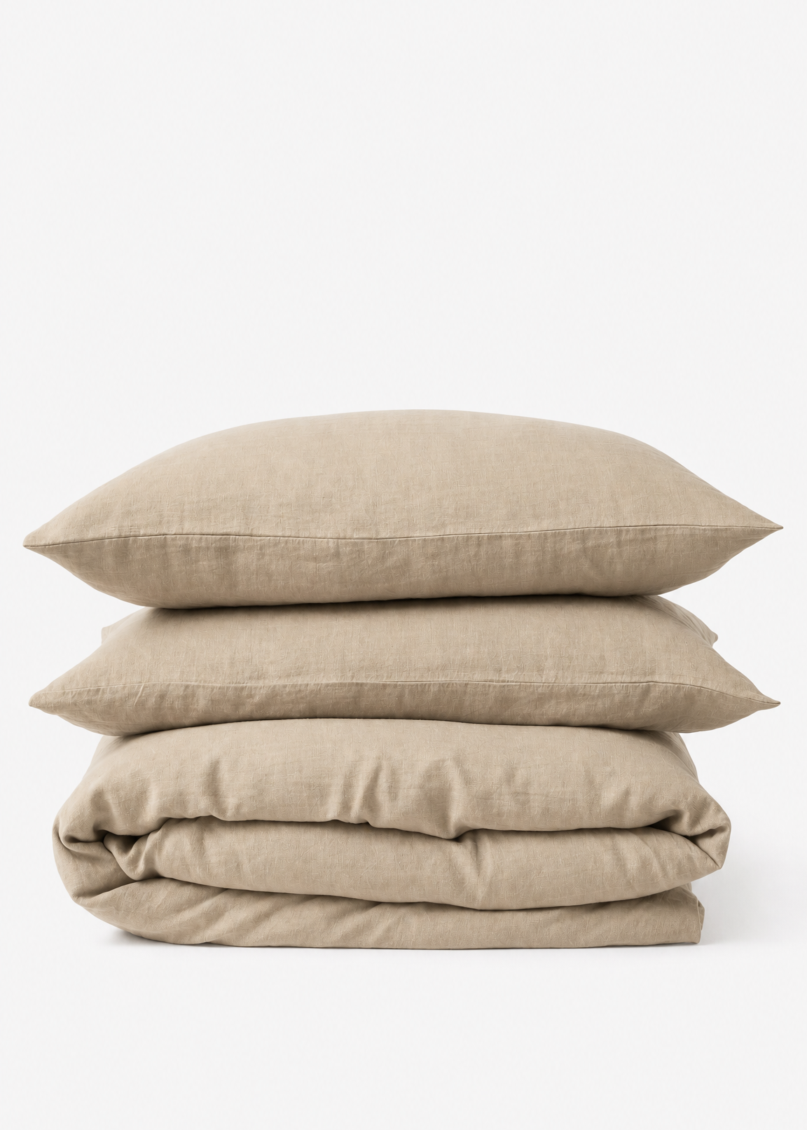 Beige bedding set with duvet and pillows on a white background