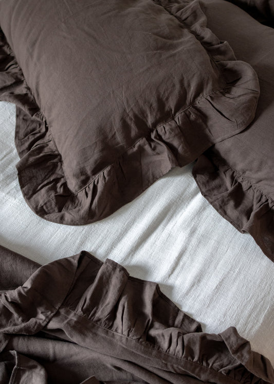 Brown bedding on a bed with white sheets, online in New Zealand