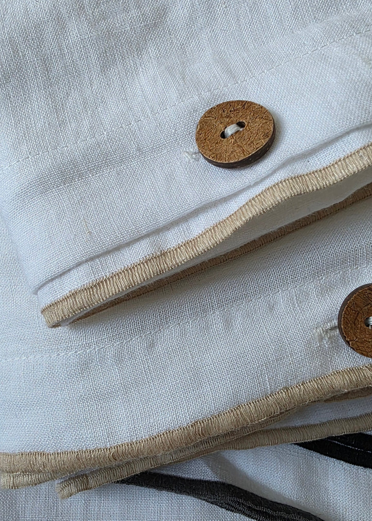 Close-up of a textured fabric with buttons and a striped pattern