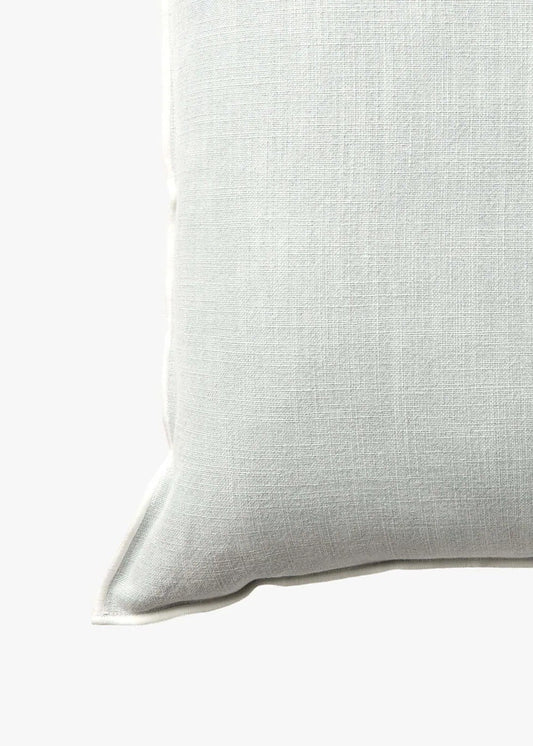 A square throw pillow in a light sage green linen fabric, shown against a plain white background.