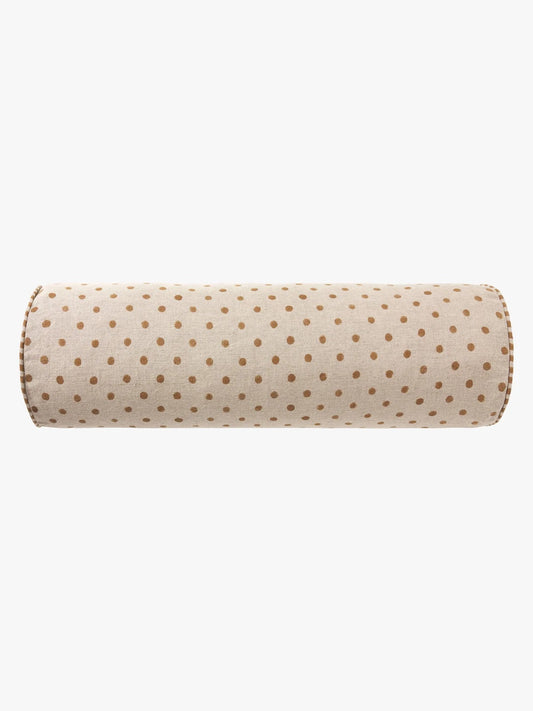 A cylindrical bolster pillow with a beige fabric cover featuring a repeating pattern of small brown polka dots, shown against a plain white background.