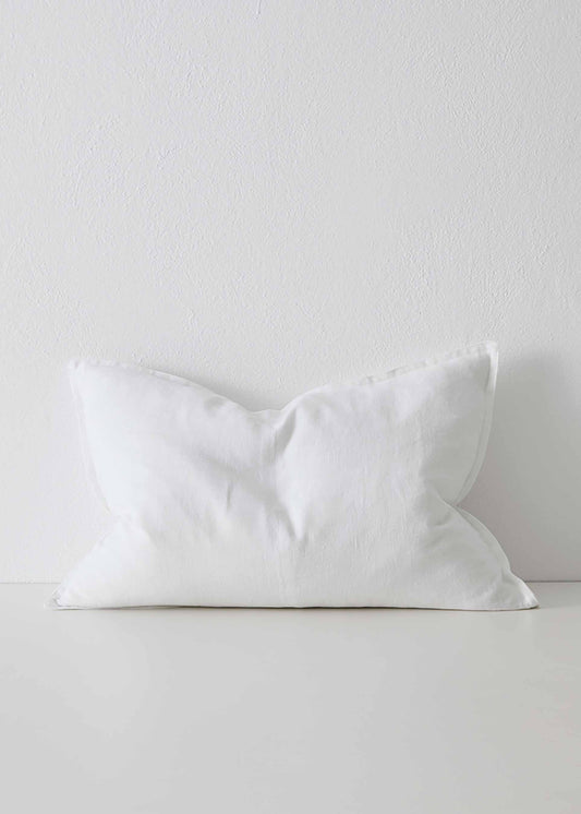 A white linen cushion with a feather inner, displayed against a neutral background.
