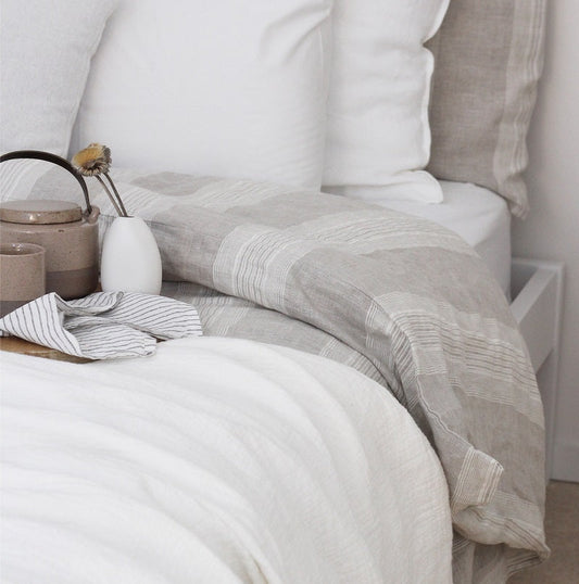 Striped linen duvet cover in soft neutral tones on an oversized bed — The Foxes Den