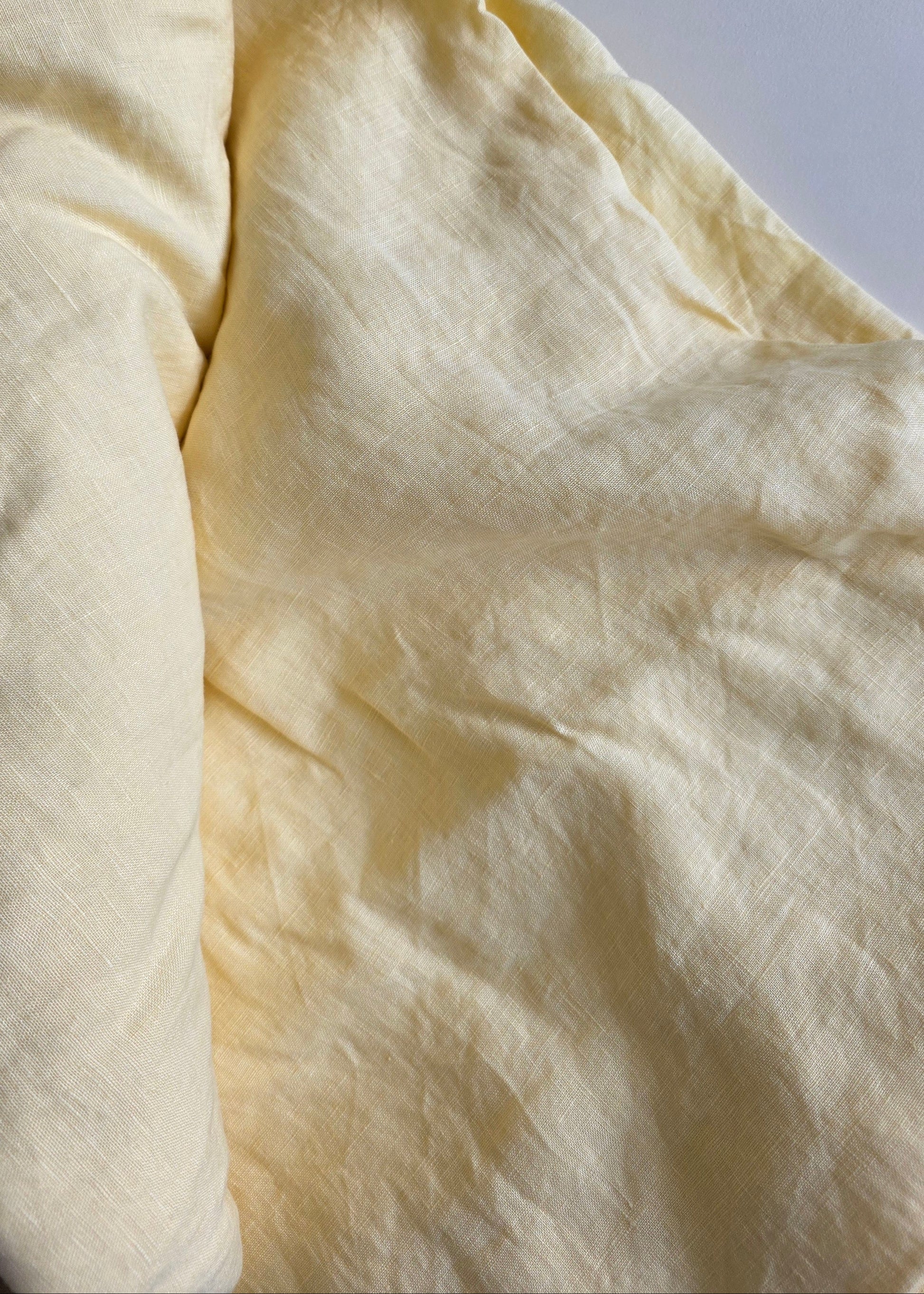 Close-up of a light yellow fabric on a white background