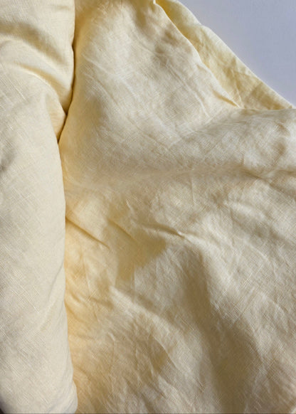 Close-up of a light yellow fabric on a white background