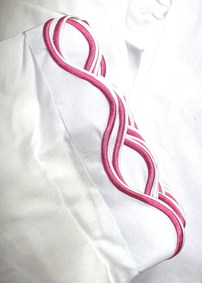 White fabric with pink embroidery on a white background