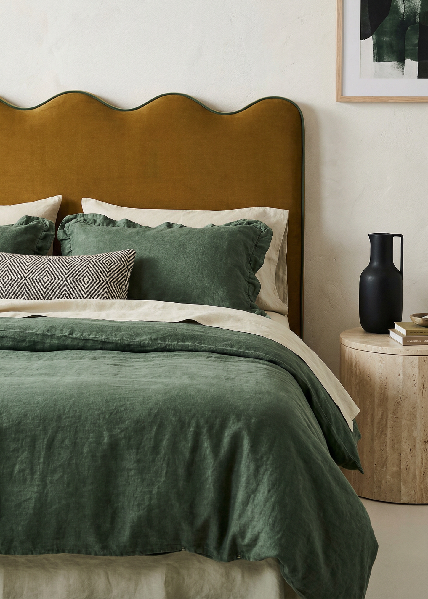 Bedroom with green bedding and a brown headboard