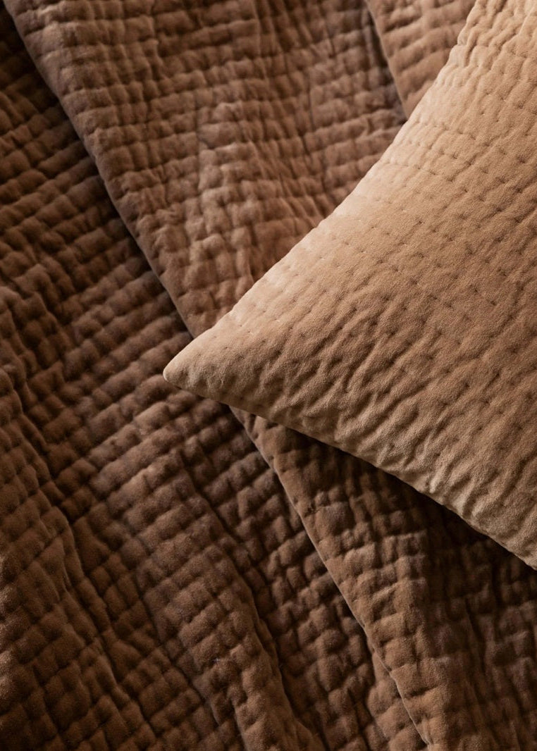 Close-up of brown textured fabric with a pillow