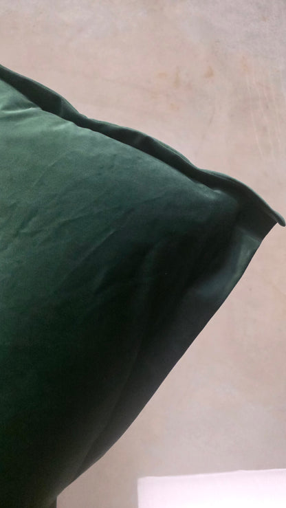 Green pillow on a beige surface