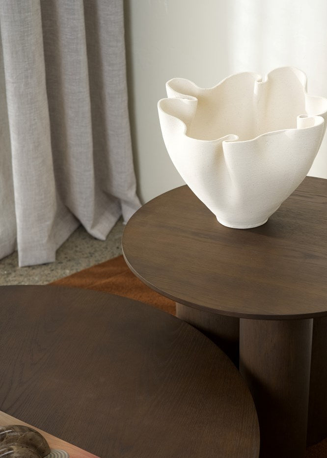 White ceramic bowl on a wooden table with a neutral background