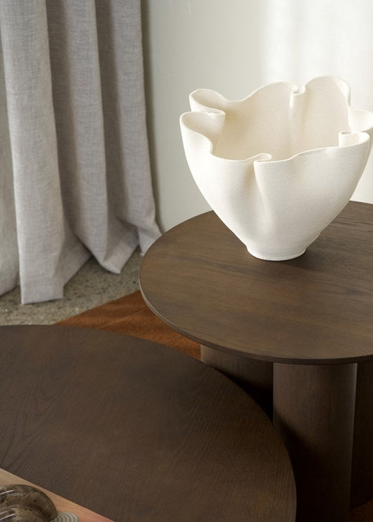 White ceramic bowl on a wooden table with a neutral background