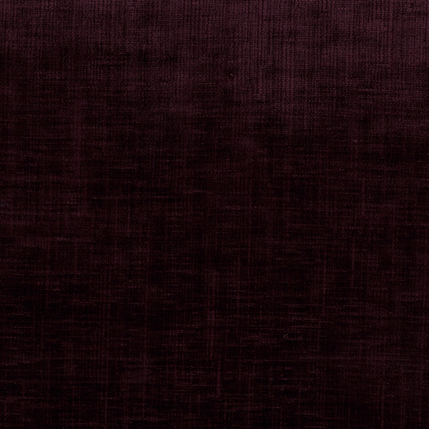 A close-up of a dark plum purple textured fabric with a subtle woven pattern.