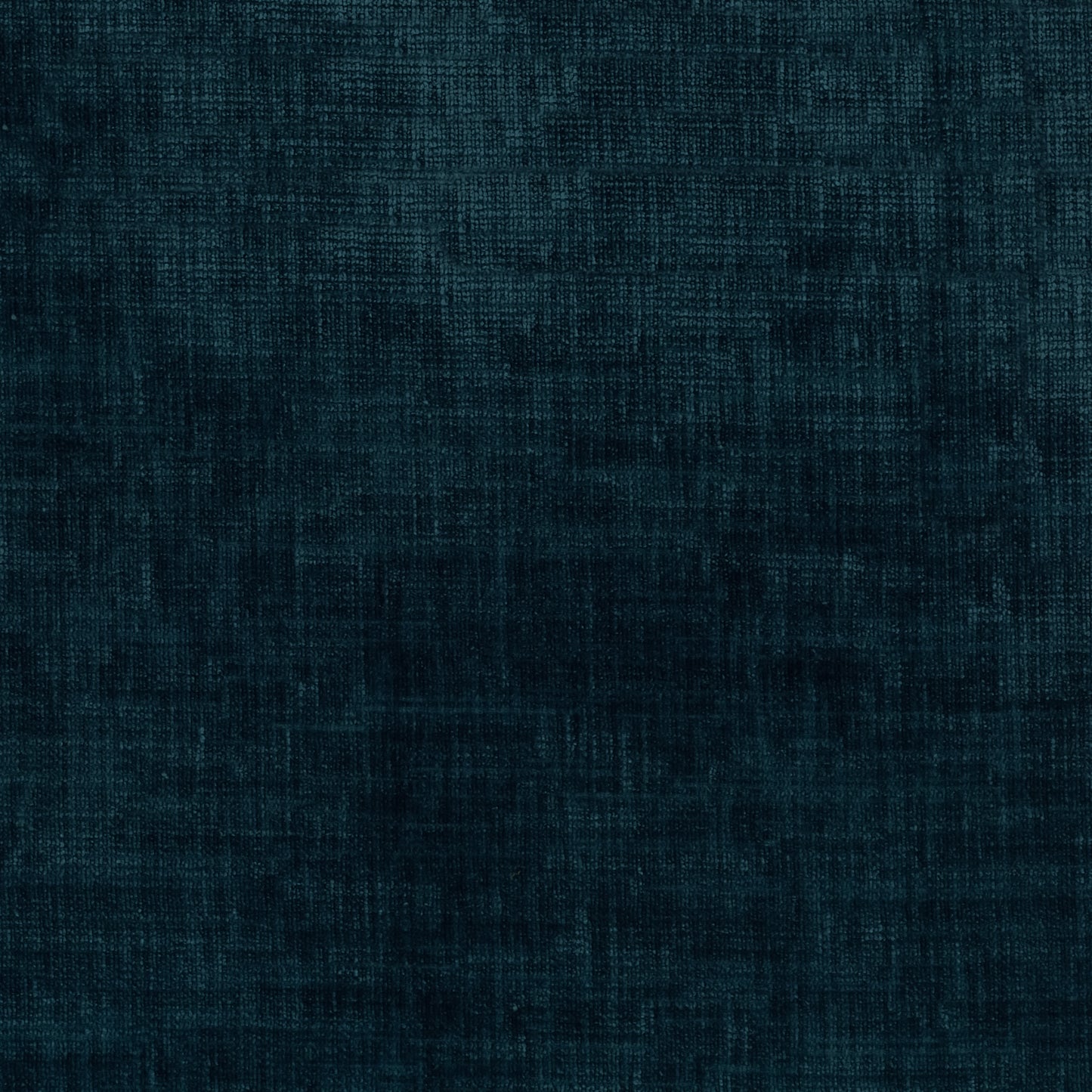 A close-up of dark teal blue textured fabric with a fine woven or linen-like pattern.