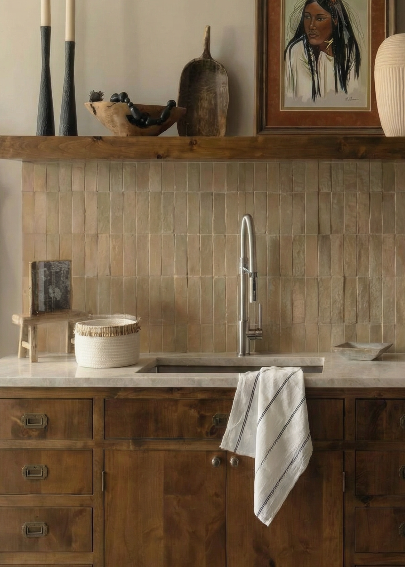 Bathroom with wooden vanity, tiled wall, and framed picture