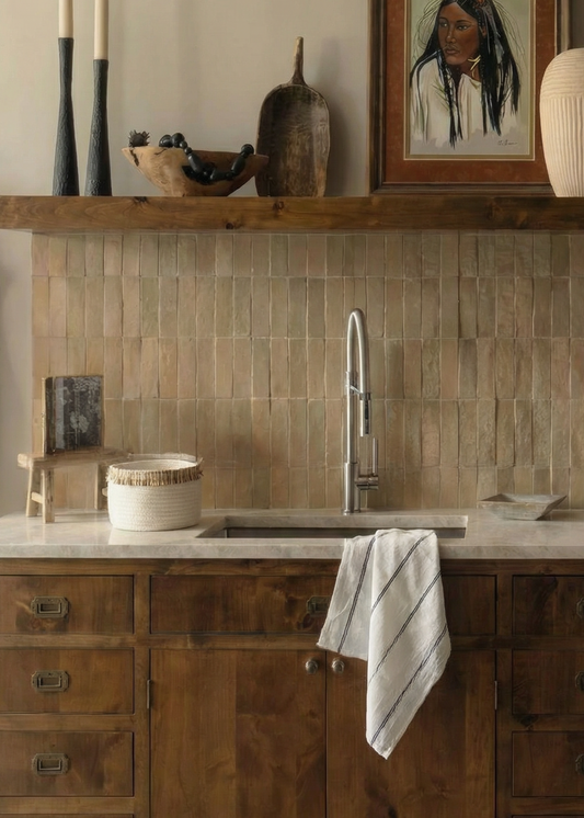 Bathroom with wooden vanity, tiled wall, and framed picture