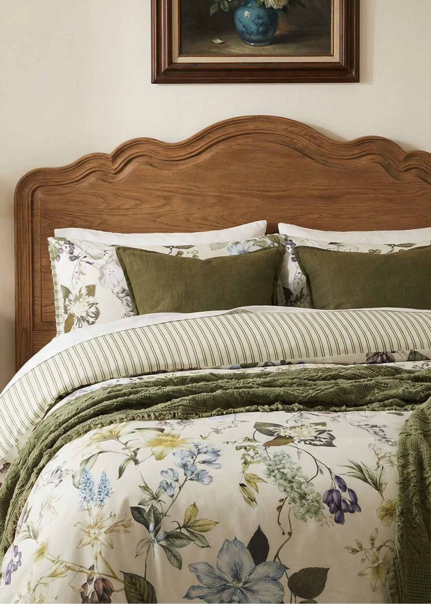 Bedroom with wooden headboard, floral bedding, and framed artwork on wall.