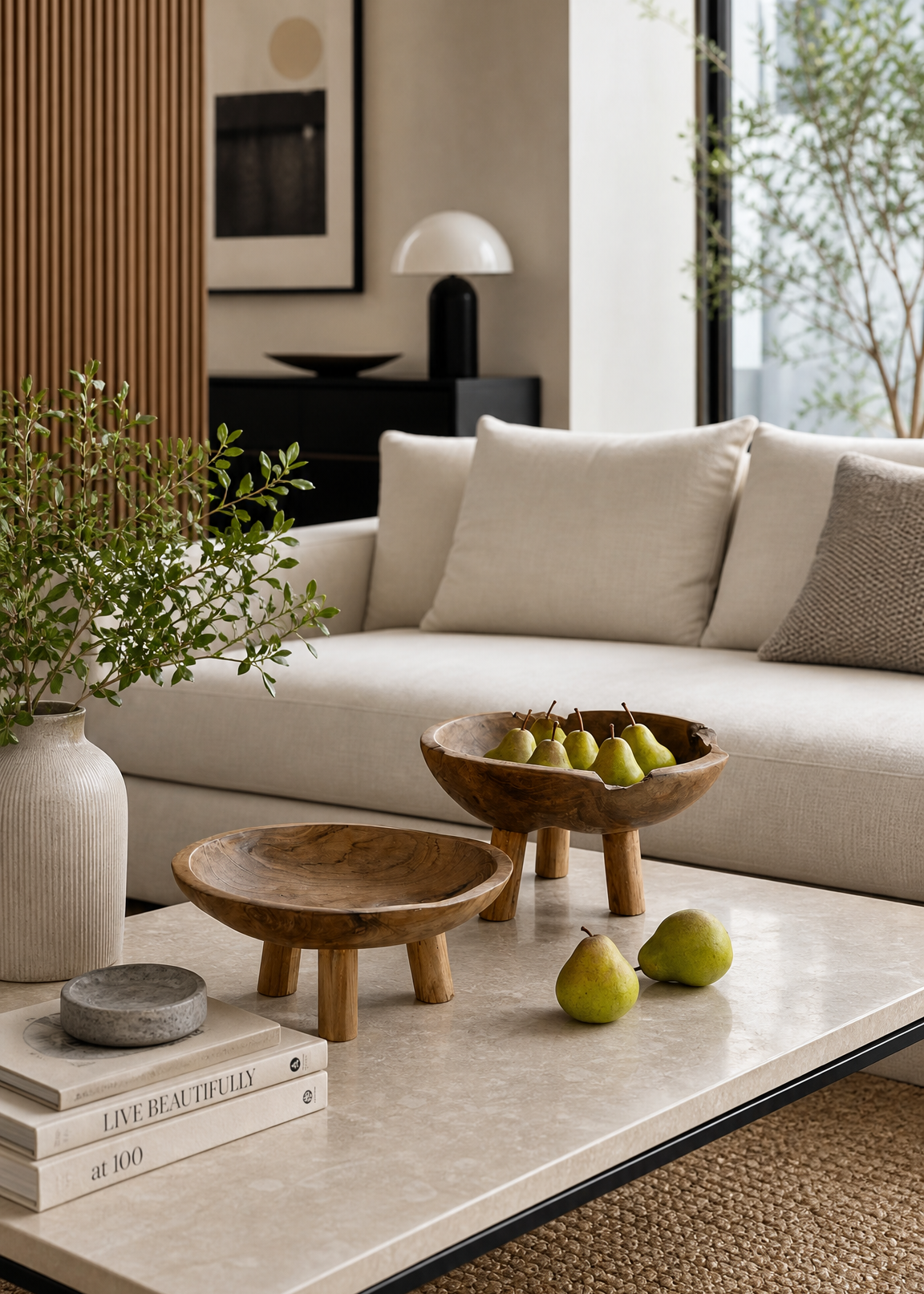Modern living room with a beige sofa, coffee table, and decorative items.