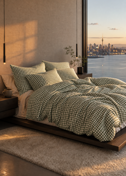Modern bedroom with green checkered bedding, city skyline view, and large window.