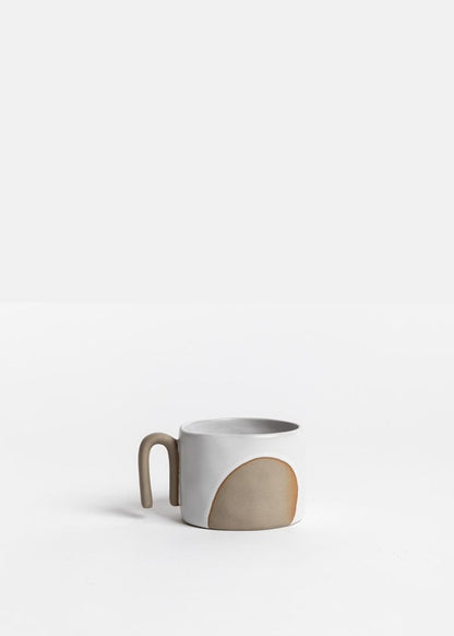 Ceramic mug with a two-tone design on a white background