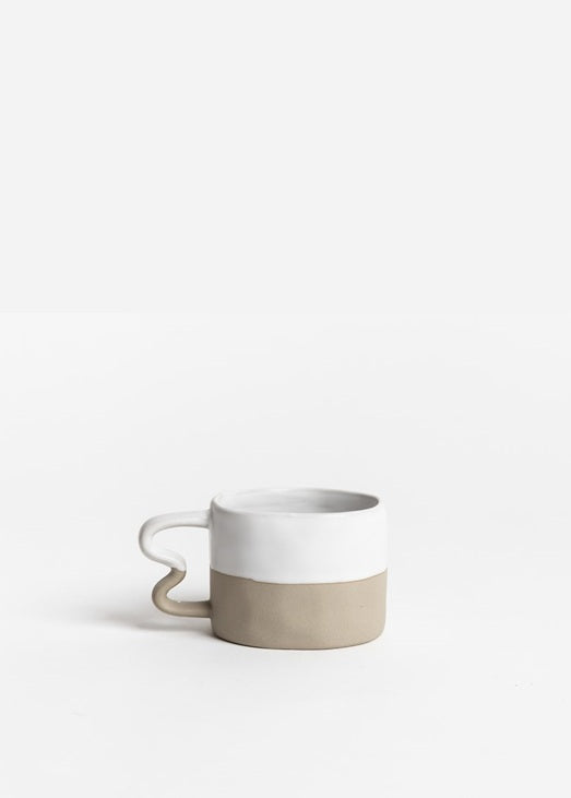Ceramic mug with two-tone design on a white background