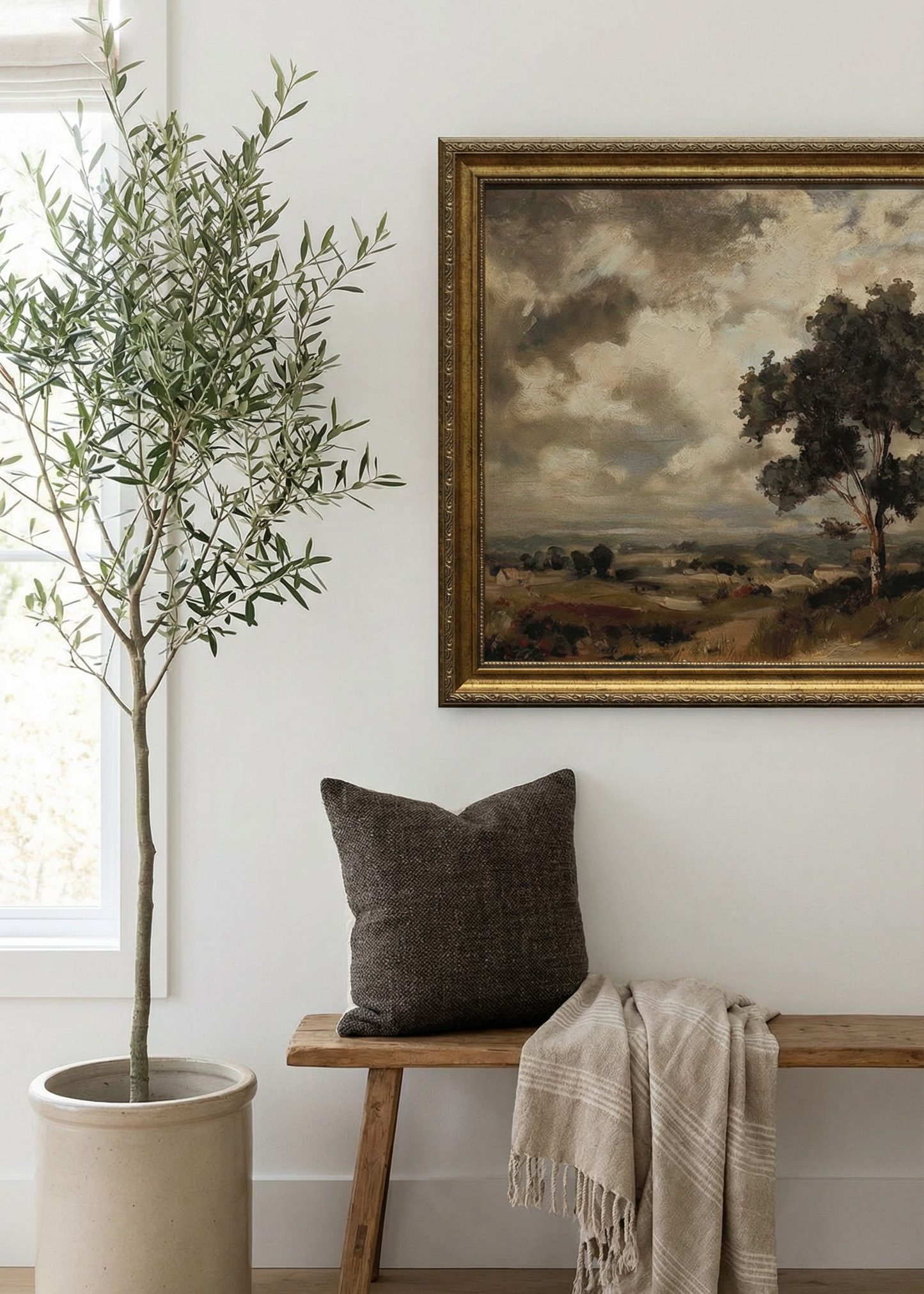 Nestled corner with a wooden bench, potted plant, and framed landscape painting.