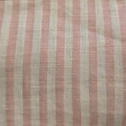 Striped fabric swatch with a visible brand label on a dark background
