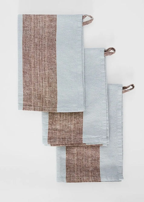 Set of three striped towels in brown and blue on a white background