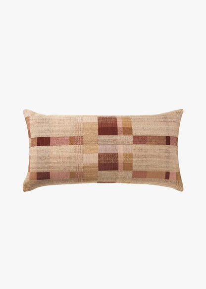 A rectangular lumbar throw pillow with a textured plaid pattern in shades of beige, brown, and muted pink, shown against a plain white background.