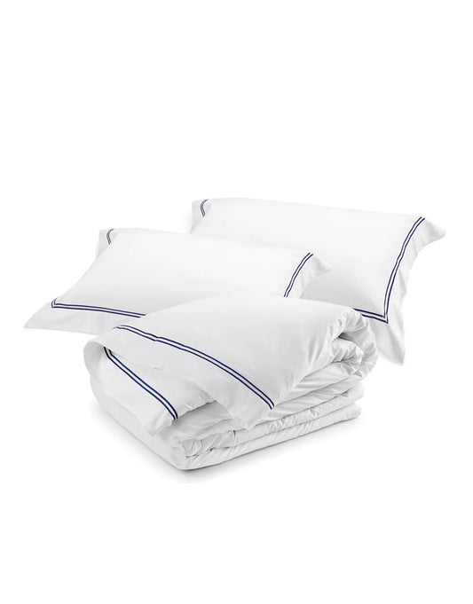 White duvet with blue piping and matching pillows on a white background