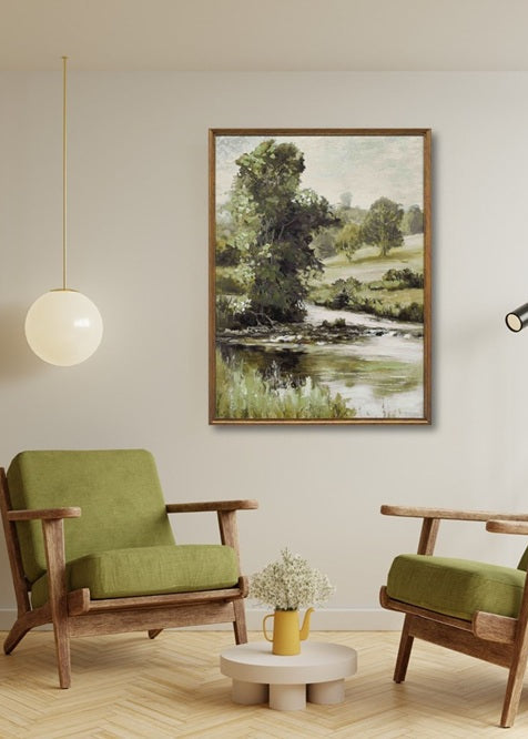 Two green armchairs in a living room with a landscape painting on the wall.
