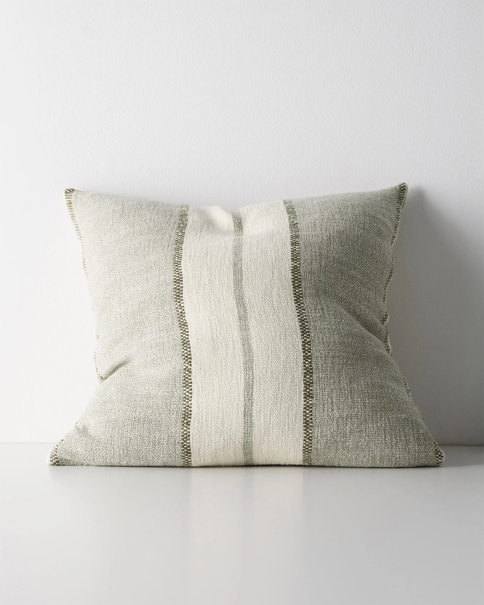 A square throw pillow with a textured linen-like fabric in a light sage green and cream color combination, featuring three vertical stripes with varying widths.