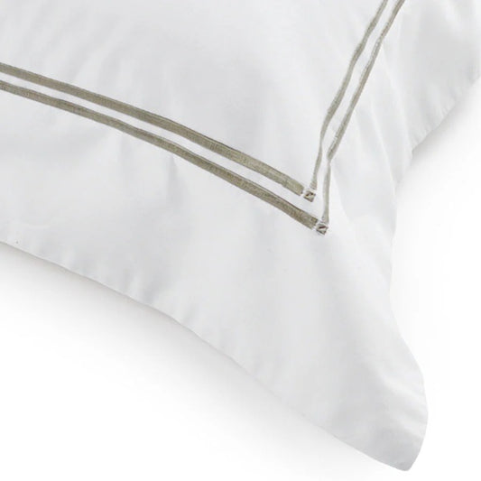 White pillow with a thin green stripe on a white background