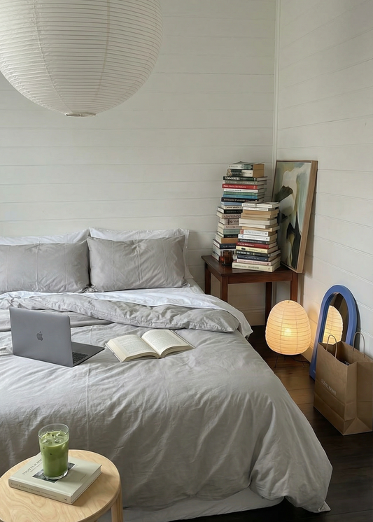 Cozy bedroom with a bed, side tables, and books.