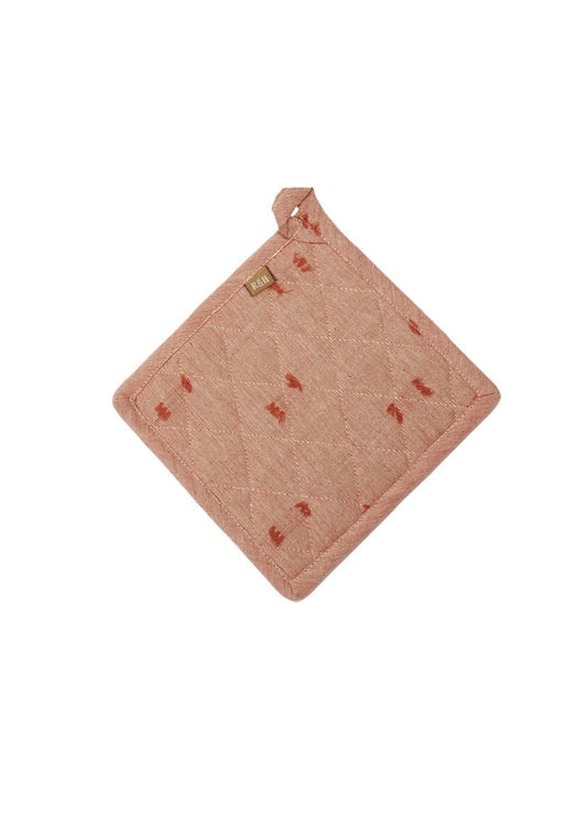 Pink textured pot holder with small red patterns on a white background