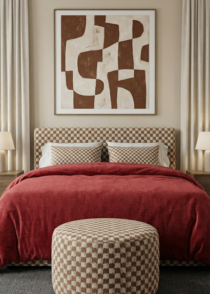 Bedroom with red bedding, checkered headboard, and abstract art on the wall.