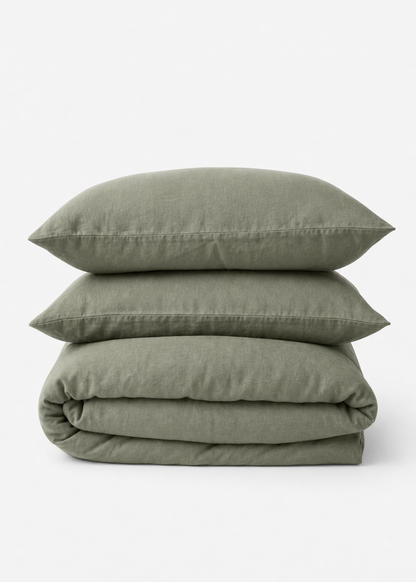 Stack of green bedding including a duvet and two pillows on a white background