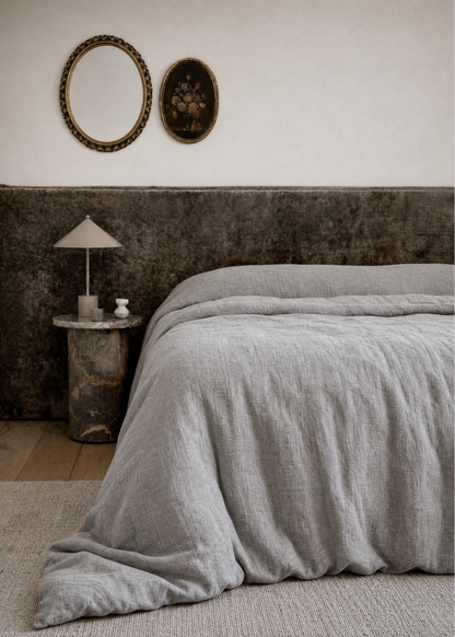 Brown bedspread and pillows with sunlight filtering through a window.