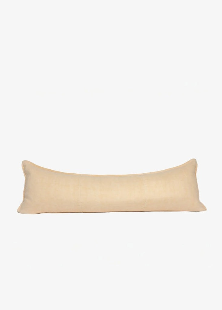 A long, rectangular lumbar pillow in a light beige linen fabric, shown against a plain white background.
