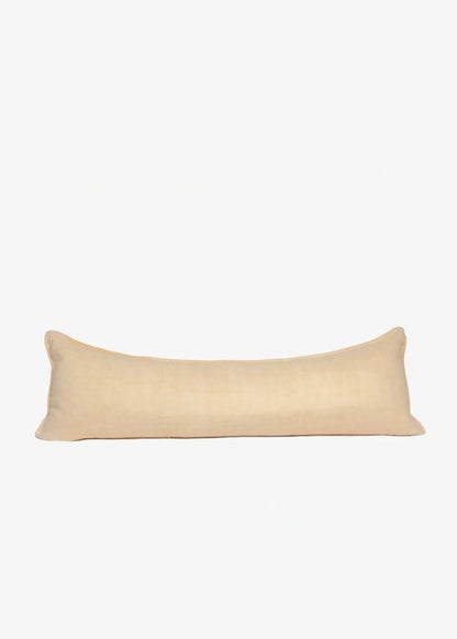 A long, rectangular lumbar pillow in a light beige linen fabric, shown against a plain white background.