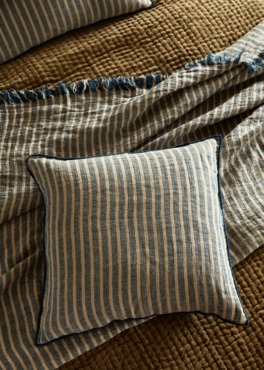 Striped pillow on a textured brown blanket