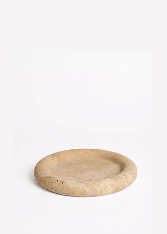 Round beige stone coaster on a white background