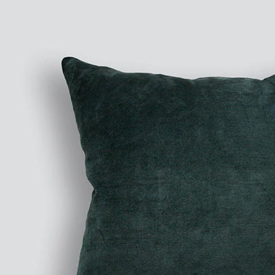 Dark green pillow on a light gray background