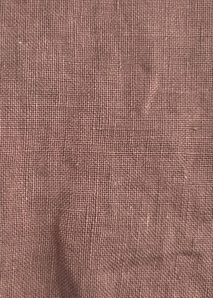 A square piece of textured brown linen fabric with frayed edges, laid flat on a light gray background.