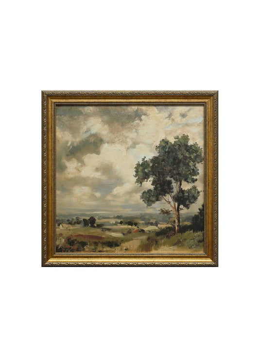 Framed landscape painting with a tree and open field on a white background